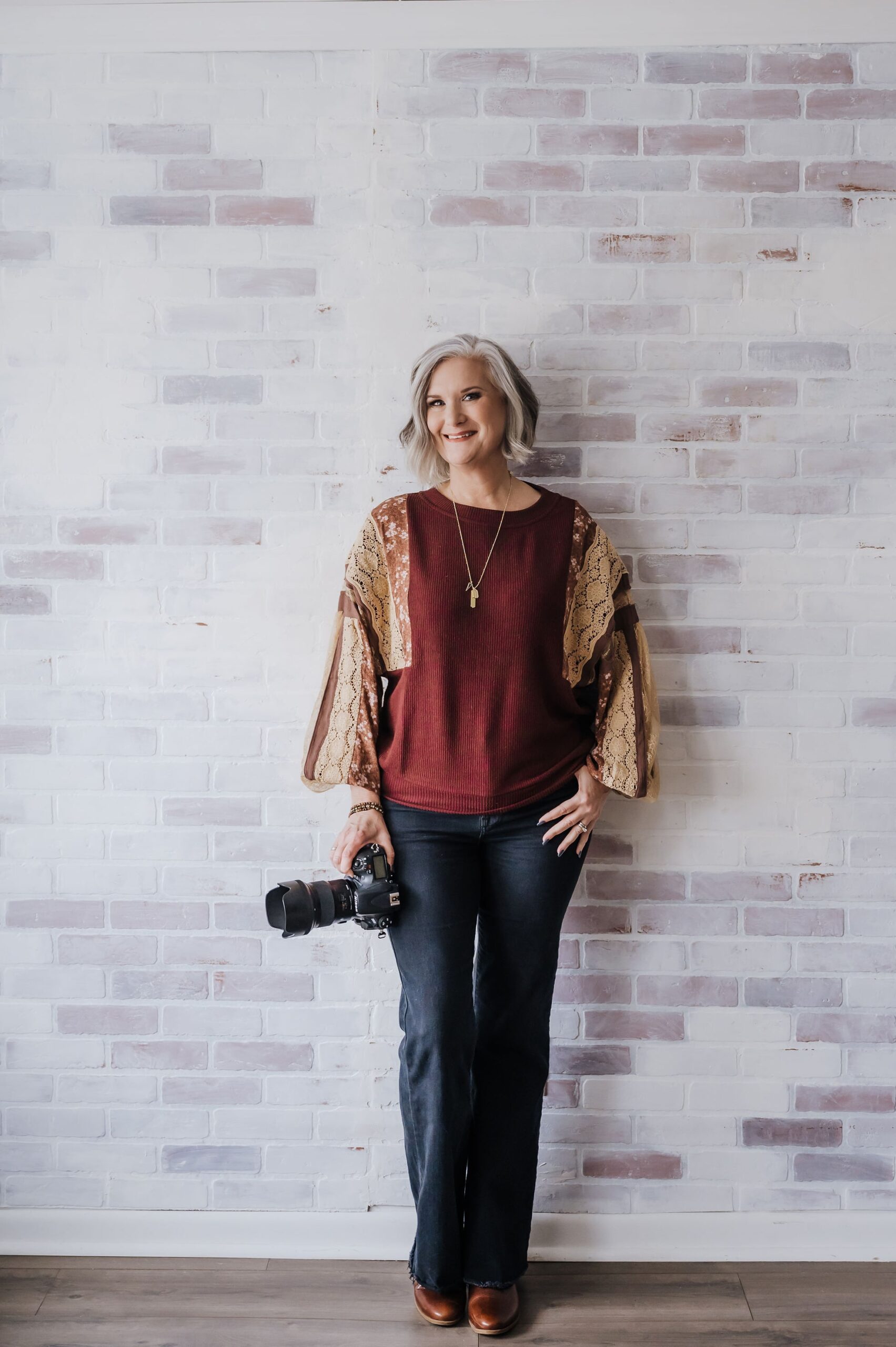 photo of Stephanie Wallace standing holding camera